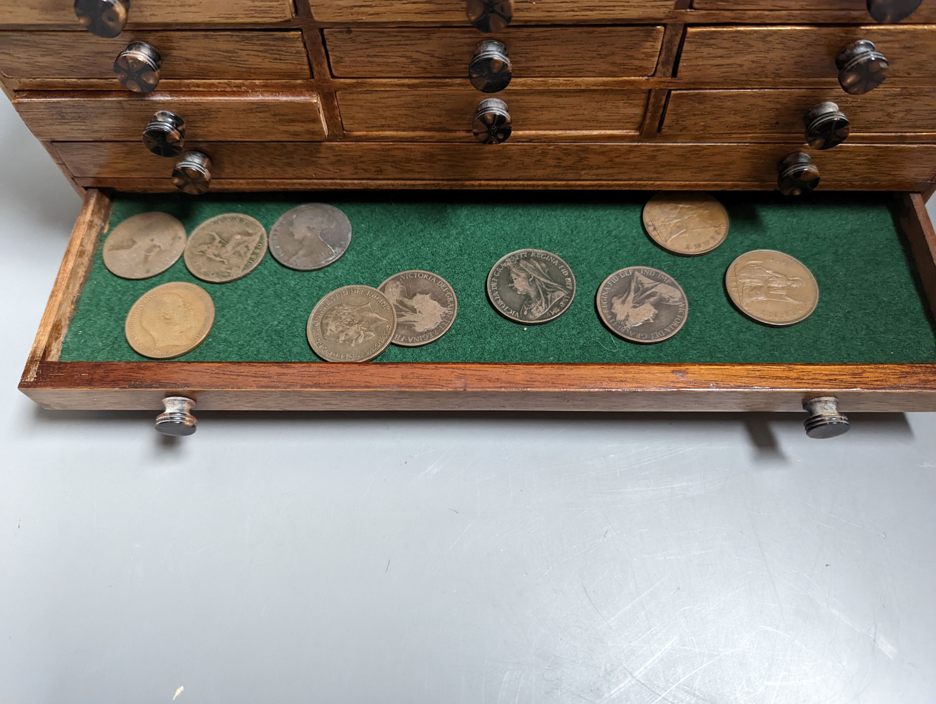 A collection of coins Victoria to Elizabeth II, together with a small coin cabinet and various reference books